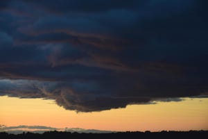 Dark clouds in front of a sunny background