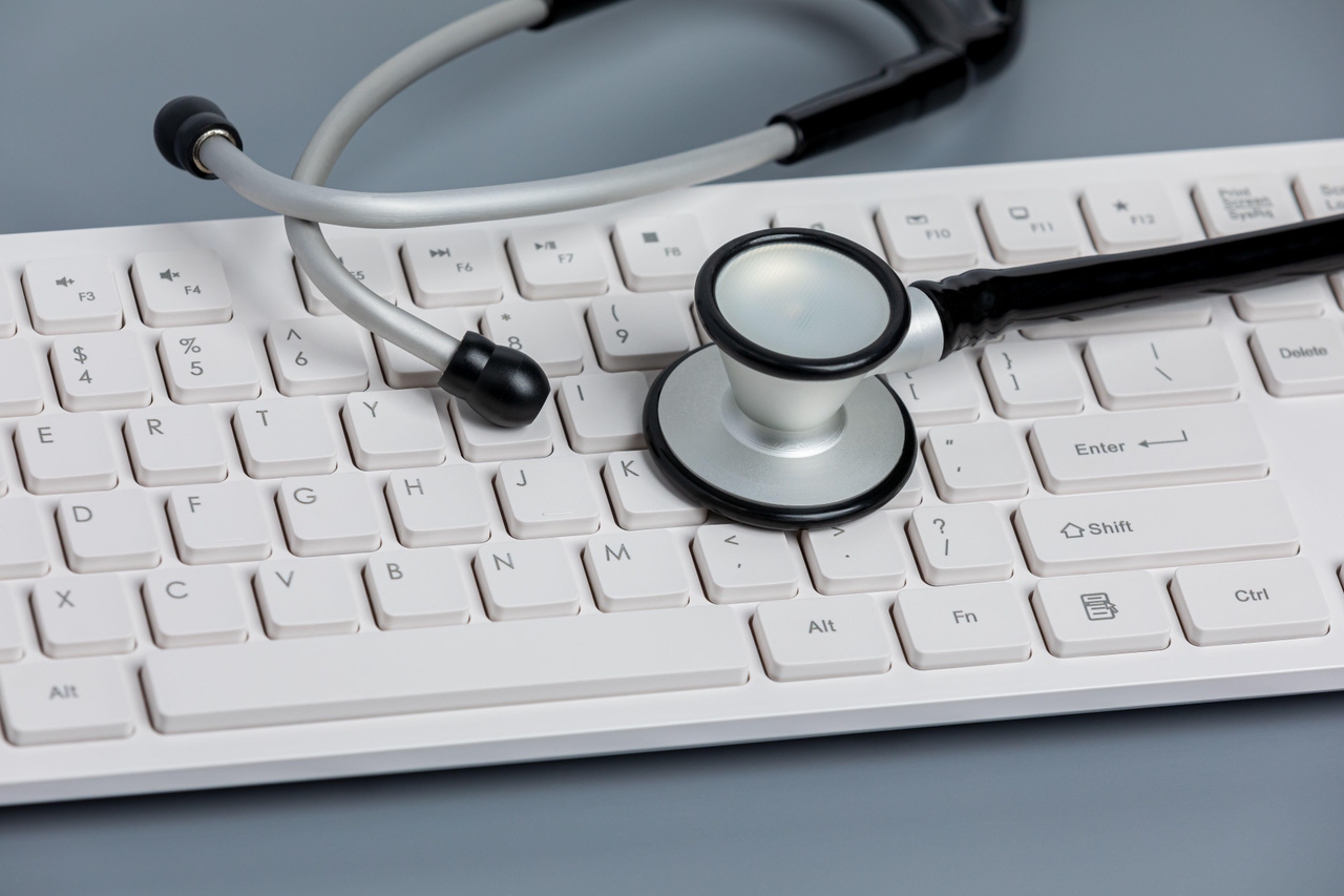 a stethoscope on top of a white keyboard