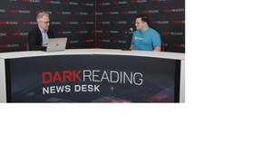 Two people talking at a news desk against a dark backdrop with "Dark Reading" written on it.