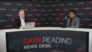 Two people talking at a news desk against a dark backdrop with "Dark Reading" written on it.