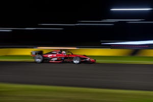 a race car on a track against a blurred background 