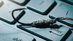 A fishhook laid atop the enter key on a computer keyboard