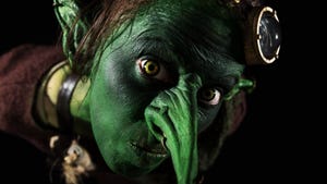 Closeup of a green female goblin with long nose and ears