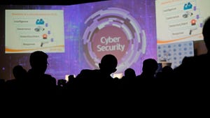 The silhouette of audience members watching a cybersecurity panel