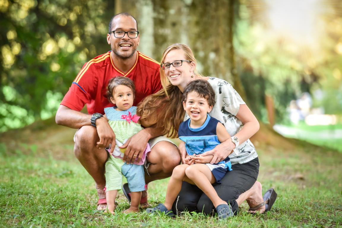 A family with two young children posing for a portrait.