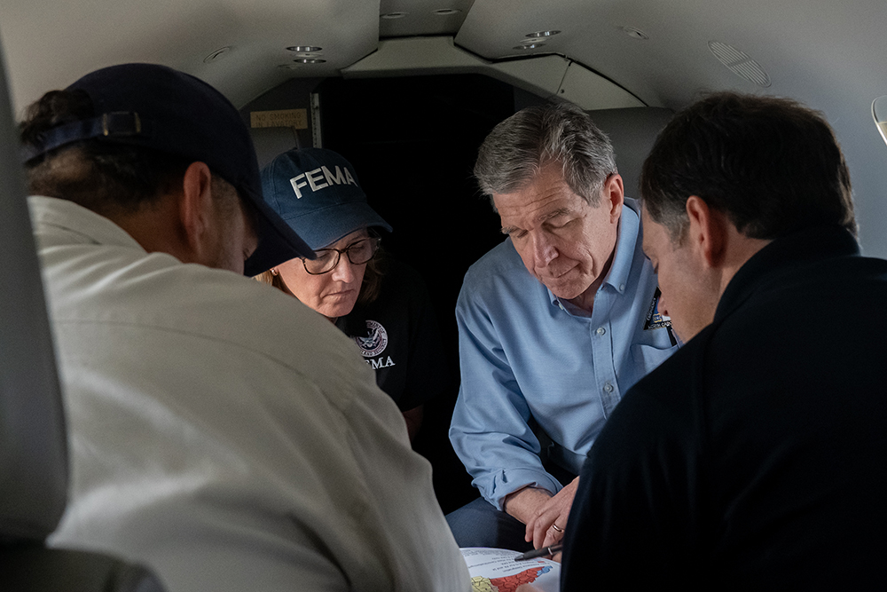 Governor Roy Cooper with FEMA representative aboard helicopter