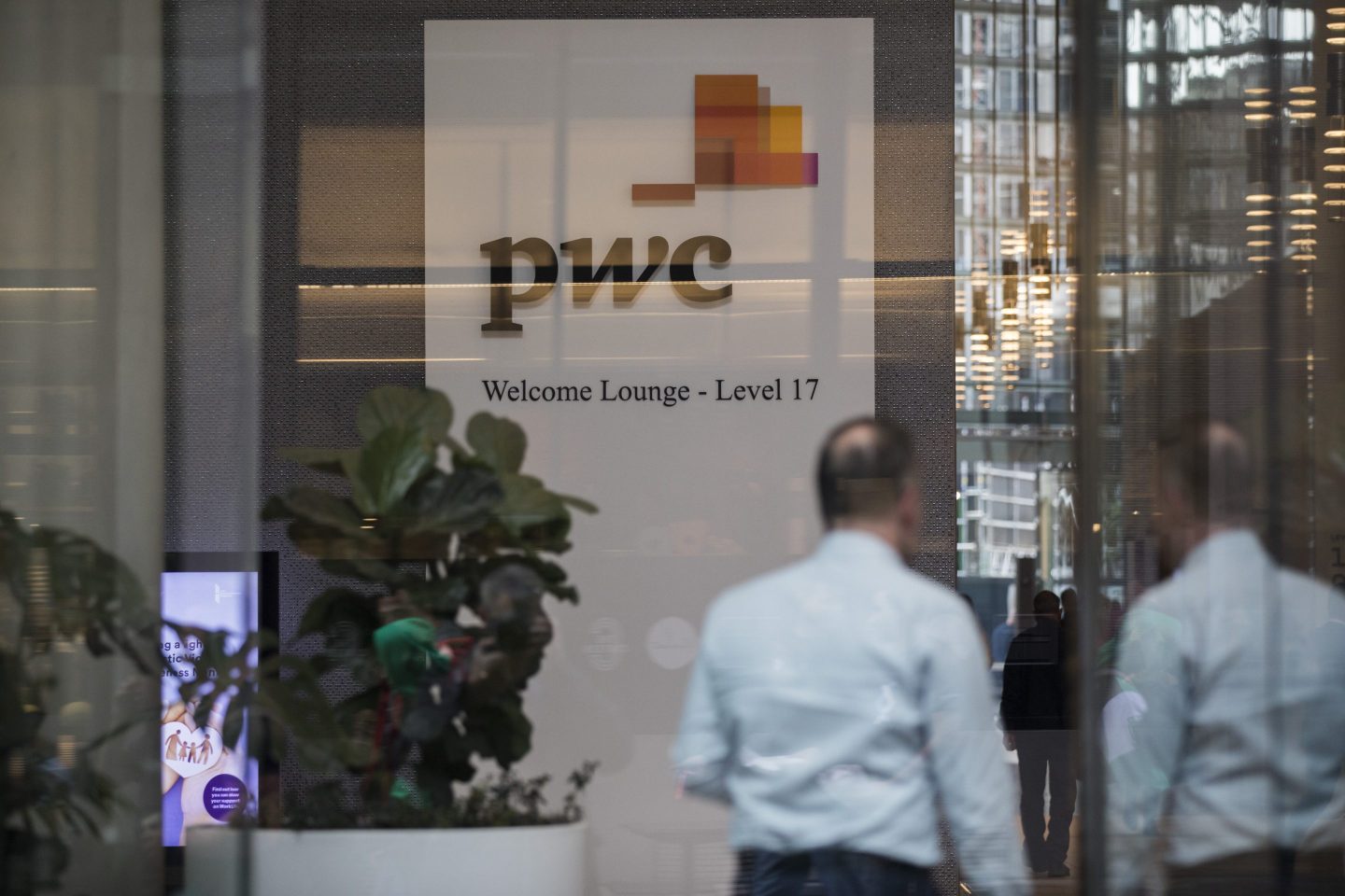 Signage at the lobby of PricewaterhouseCoopers Australia office in Sydney, Australia, on Thursday, May 25, 2023. The Australian government has referred a PwC tax scandal to the police and asked them to consider a criminal investigation as political scrutiny mounts. Photographer: Brent Lewin/Bloomberg via Getty Images