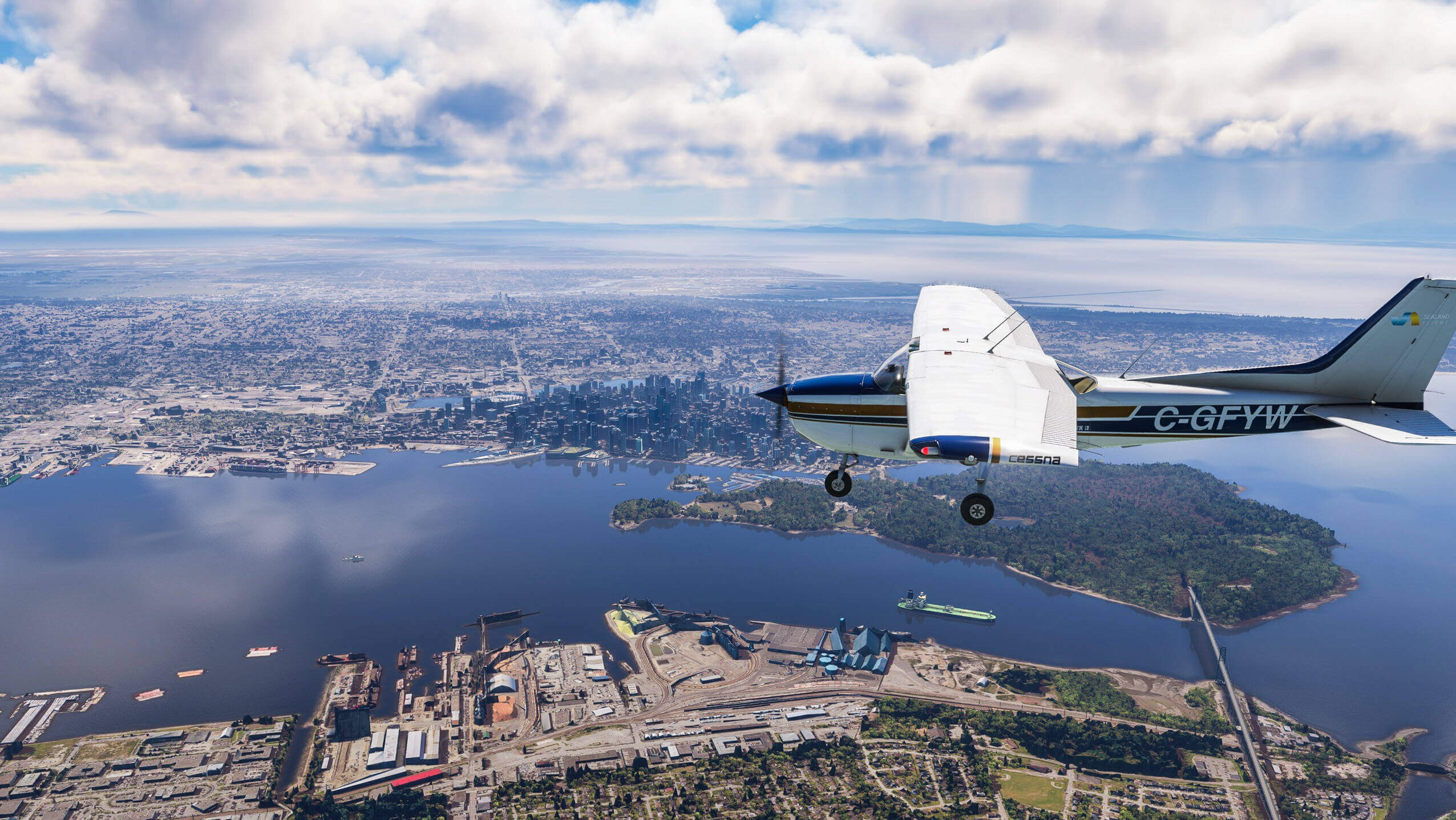 A Cessna 172 flies close by to a cityscape with scattered clouds casting shadows on the buildings below