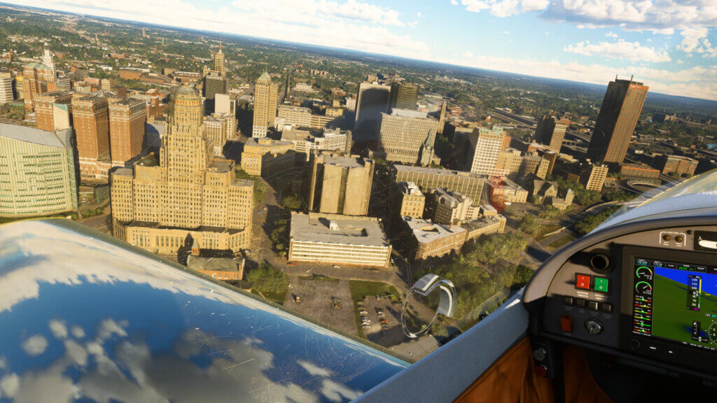 Looking out the window of a plane over a city