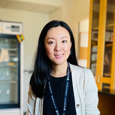 Asian woman smiling in a lab