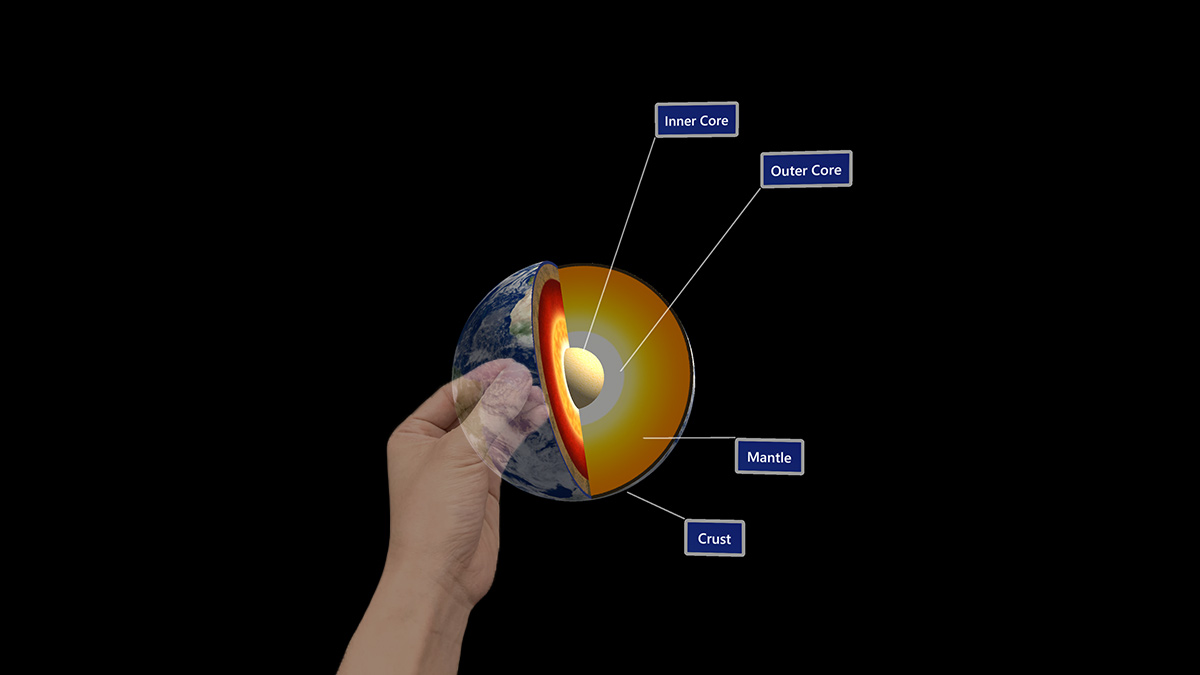 A hand manipulating a digital model of the Earth.