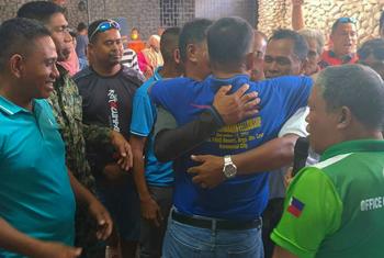 Families embrace as they agree to end a decades-long feud.