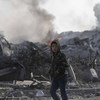 A 12-year-old boy walks past houses destroyed by Israeli airstrikes, in the city of Rafah, in the southern Gaza Strip. (November 2012)