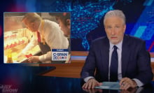 A man in a suit sits behind a talk show desk. In the top-left is a photo of a man at McDonald's.