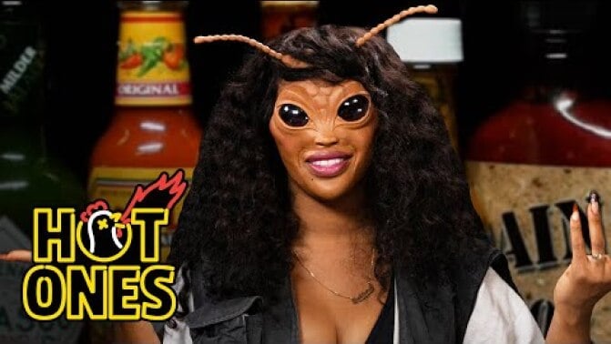 SZA in bug prosthetics on 'Hot Ones.'