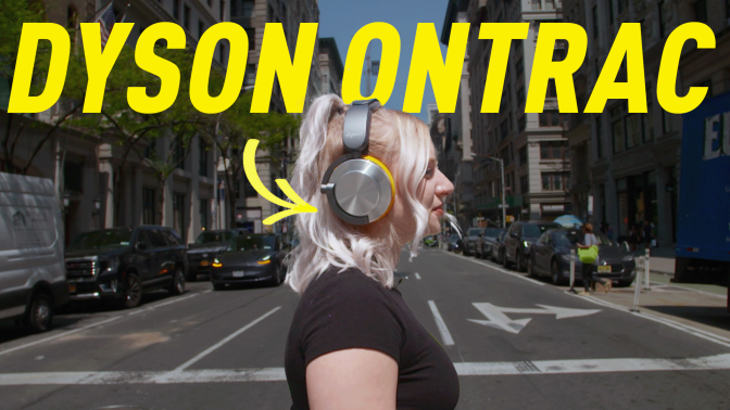 a woman crossing a busy street wearing the Dyson Ontrac headphones