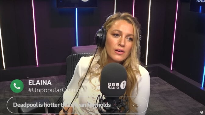 A woman sits in a radio studio wearing headphones.