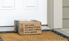 Amazon package sitting on doormat in front of door