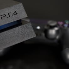 A logo sits on the front of a Sony PlayStation 4 (PS4) games console, manufactured by Sony Corp., in this arranged photograph taken in London, U.K.