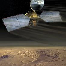 An artist's conception of the Mars Reconnaissance Orbiter swooping over the Martian desert.