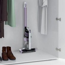 Shark Pet cordless vacuum in white closet next to shoes