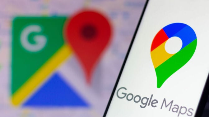 The Google Maps logo seen displayed on a smartphone and in the background.