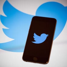 The Twitter logo on a smartphone.