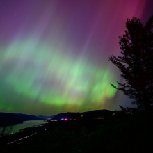 The Northern Lights are seen above the Columbia River Gorge from Chanticleer Point Lookout in the early morning hours of May 11, 2024 in Latourell, Oregon.