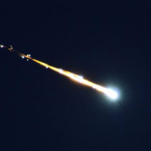 A fireball breaking apart in Earth's atmosphere.