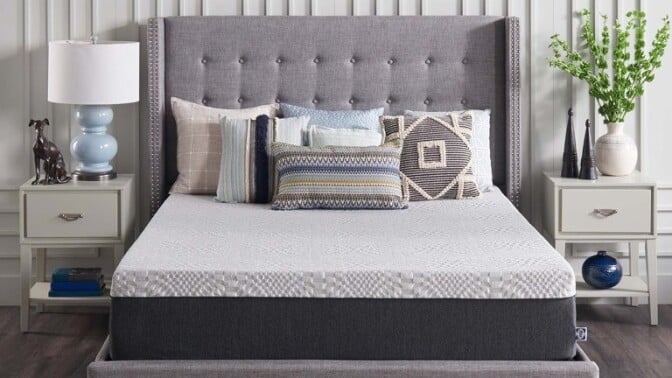 a sealy bed in a bedroom with gray and blue tones