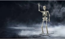 a giant, waving skeleton against a foggy background 