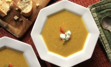 Soup and bread on a table.