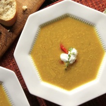 Soup and bread on a table.