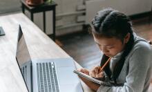 girl with braided pigtails sitting at computer