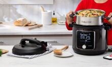 Person lifting Instant Pot inner pot with oven mitts