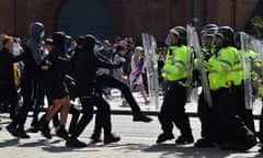 Rioters facing off against a line of police in Liverpool