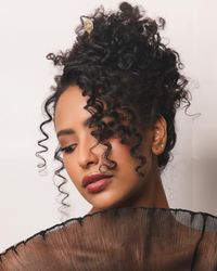 A textured updo on @kholoodofficial Makeup @megohareartistry #hairbynikirae @paulmitchellpro 3in1 curling iron @igk good behavior & please hold @tidalhairsticks #hairstylist #curlyhair #updohairstyles #updo