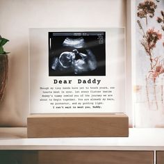 "Introducing our heartfelt and personalized \"Dear Daddy\" Ultrasound Acrylic Plaque with LED, the perfect gift for a first-time dad and an extraordinary way to celebrate the joy of impending fatherhood. This unique plaque, made with premium acrylic, captures the essence of the special bond between an expectant father and his unborn child. The sharp and detailed printed design beautifully showcases the precious ultrasound photo, preserving the first glimpse of your little one. This personalized ultrasound gift is a profound way to commemorate this milestone and create a lasting memory for the father-to-be. Acrylic Plaque Details: ✨ Premium acrylic  ✨ Size with wooden base: 6.5\" (165mm) height x 6.5\" (165mm) width ✨ Acrylic Depth: 0.1\" (5mm) ✨ Wooden base: 1.2\" (30mm) height x 6.5\" (16 Ultrasound Frame, Photo Led, Expectant Father, First Time Dad Gifts, New Dad Gift, First Time Dad, First Fathers Day Gifts, Baby Frame, Acrylic Plaque