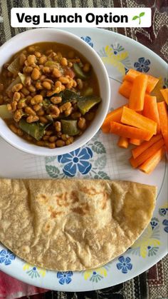 the meal is prepared and ready to be eaten with carrots, beans, and pita bread