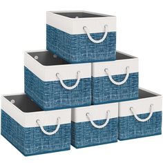 four blue and white storage baskets stacked on top of each other