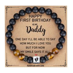 a bracelet with the words happy first birthday as my daddy on it and two black beads