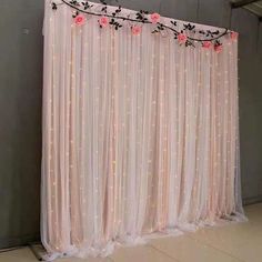 the curtain is decorated with pink flowers and lights