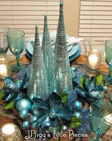 a table topped with blue glass christmas trees