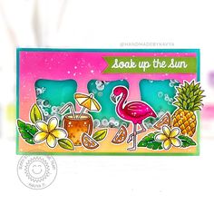 a card with an image of two flamingos and pineapples in the background