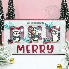 a christmas card with penguins and presents on the front, surrounded by snow - covered trees