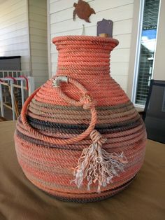 a large orange basket sitting on top of a wooden table