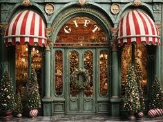 a green building with red and white awnings on it's front door