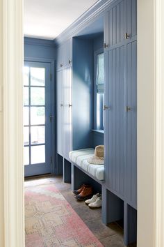 a hallway with blue walls and wooden benches