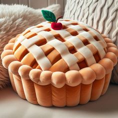 an orange and white basket sitting on top of a bed next to a teddy bear