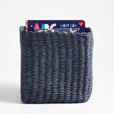 a blue basket with some books in it